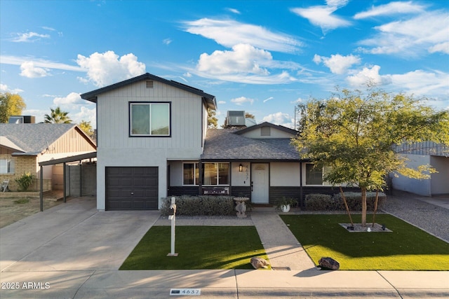 view of front of house featuring central air condition unit, a front lawn, and a garage