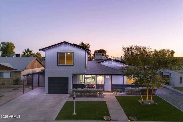 view of front of house with central air condition unit, a lawn, and a garage