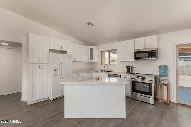 2826 E Cactus Rd, Phoenix, AZ 85032 - kitchen with appliances with stainless steel finishes, white cabinets, dark wood-style flooring, lofted ceiling, and glass insert cabinets