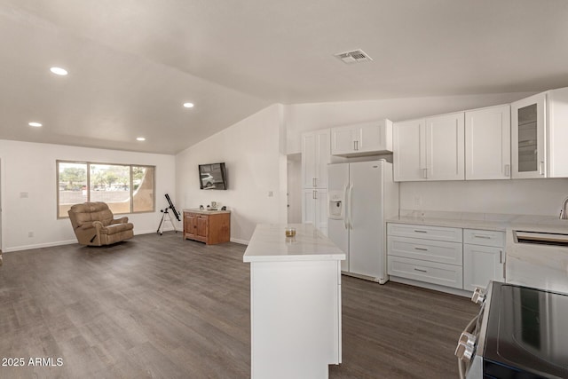 2826 E Cactus Rd, Phoenix, AZ 85032 - kitchen with stainless steel electric range oven, white refrigerator with ice dispenser, lofted ceiling, a kitchen island, and dark wood finished floors