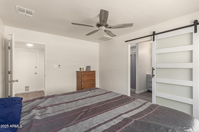 2826 E Cactus Rd, Phoenix, AZ 85032 - bedroom featuring a barn door, wood finished floors, and ceiling fan