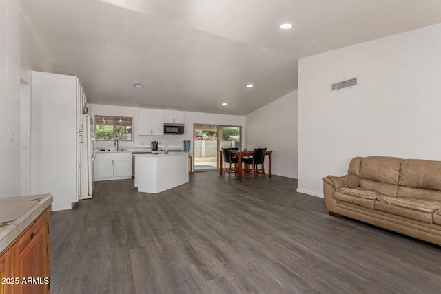 2826 E Cactus Rd, Phoenix, AZ 85032 - living room featuring recessed lighting, dark wood finished floors, and vaulted ceiling