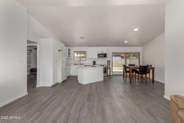 2826 E Cactus Rd, Phoenix, AZ 85032 - kitchen with stainless steel appliances, white cabinets, light countertops, a center island, and dark wood-style floors