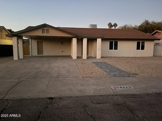 ranch-style home featuring a carport