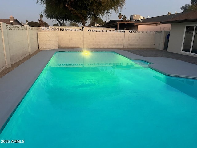 pool at dusk with central AC unit