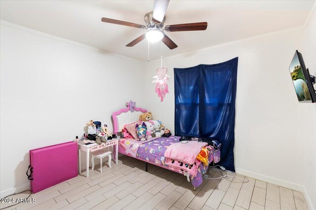 bedroom featuring ceiling fan, light hardwood / wood-style flooring, and ornamental molding