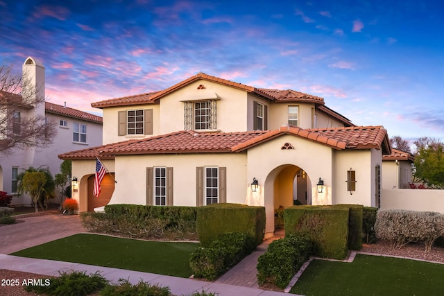 mediterranean / spanish-style home featuring a yard