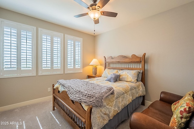 bedroom with carpet, multiple windows, baseboards, and a ceiling fan