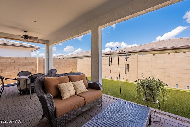 view of patio / terrace with a fenced backyard, an outdoor hangout area, outdoor dining area, and a ceiling fan