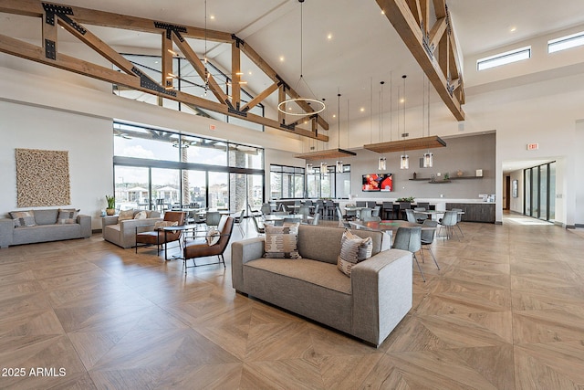 living room featuring high vaulted ceiling and beamed ceiling