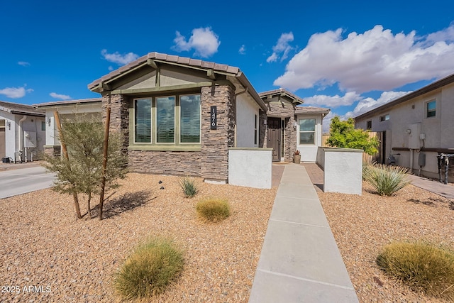 view of front of home featuring stone siding and stucco siding