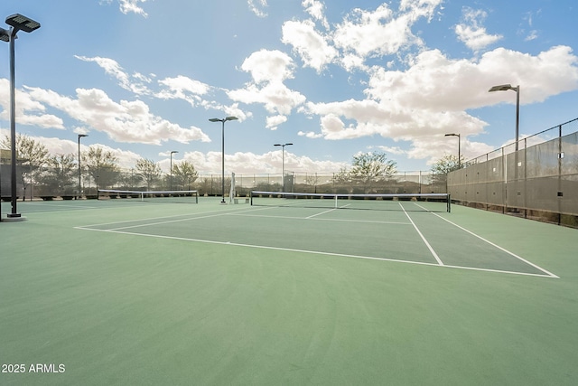 view of tennis court with fence