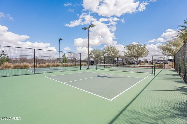 view of sport court featuring fence