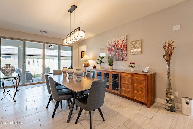 dining area with baseboards and visible vents