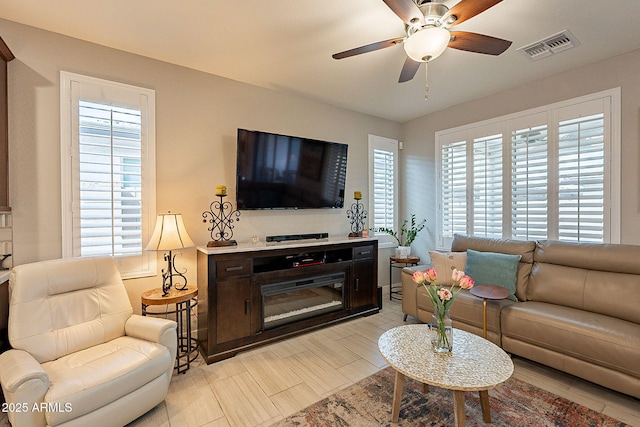 living area with visible vents and a ceiling fan