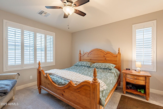 carpeted bedroom with a ceiling fan, visible vents, and baseboards