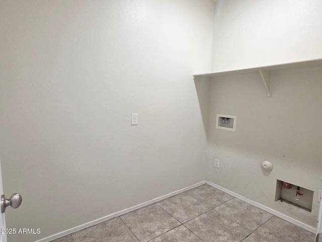 laundry area with washer hookup, light tile patterned floors, gas dryer hookup, laundry area, and baseboards