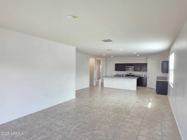 unfurnished living room featuring recessed lighting and light tile patterned flooring