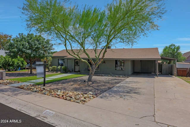 ranch-style home featuring a carport