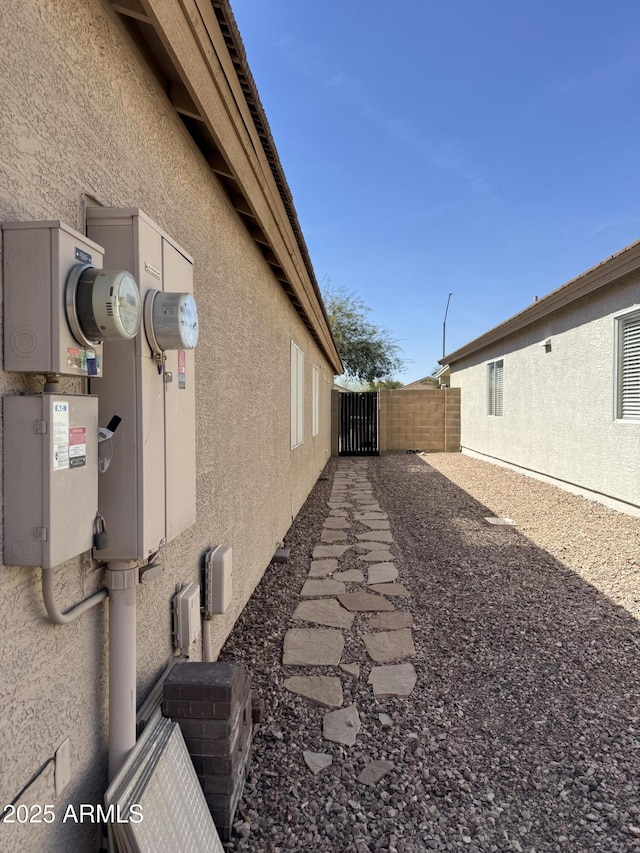 view of home's exterior featuring fence and stucco siding