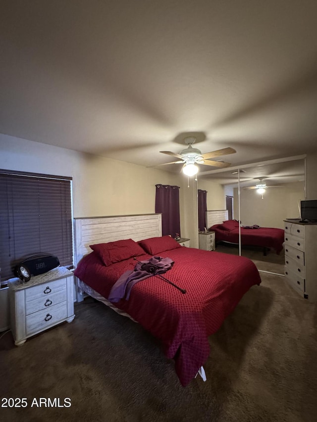 bedroom featuring ceiling fan and carpet