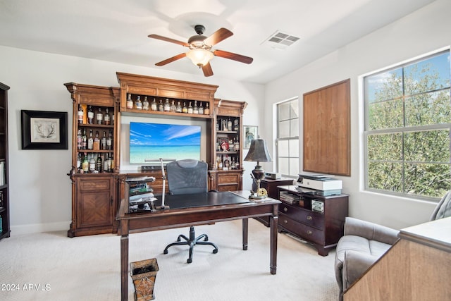 home office with ceiling fan and light colored carpet