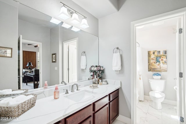 bathroom with curtained shower, vanity, and toilet