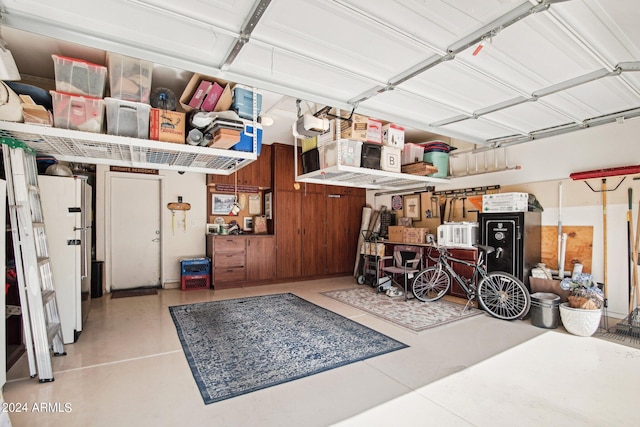 garage with white refrigerator and a garage door opener