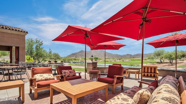 view of patio / terrace featuring a water and mountain view