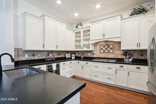 kitchen featuring white cabinetry and beverage cooler