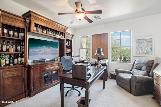 carpeted home office with ceiling fan