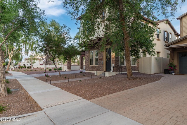 20689 W Valley View Dr, Buckeye, AZ 85396 - view of front of home featuring decorative driveway and brick siding