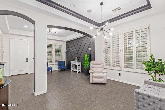 20689 W Valley View Dr, Buckeye, AZ 85396 - living area with a tray ceiling, arched walkways, baseboards, tile patterned flooring, and crown molding