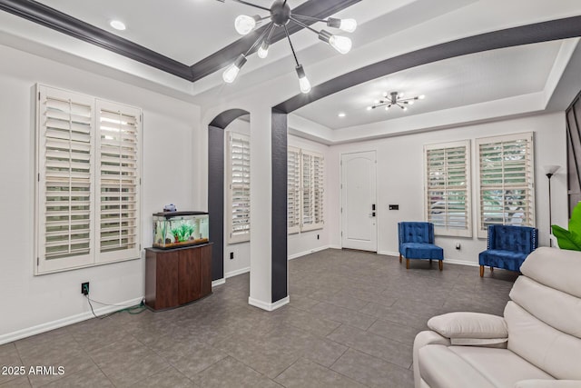 20689 W Valley View Dr, Buckeye, AZ 85396 - tiled living room with a chandelier, a raised ceiling, arched walkways, baseboards, and recessed lighting