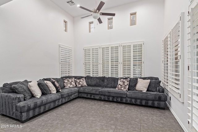 20689 W Valley View Dr, Buckeye, AZ 85396 - tiled living area featuring a ceiling fan and a towering ceiling