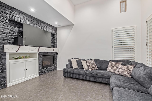 20689 W Valley View Dr, Buckeye, AZ 85396 - living room with a stone fireplace, tile patterned flooring, a towering ceiling, and recessed lighting