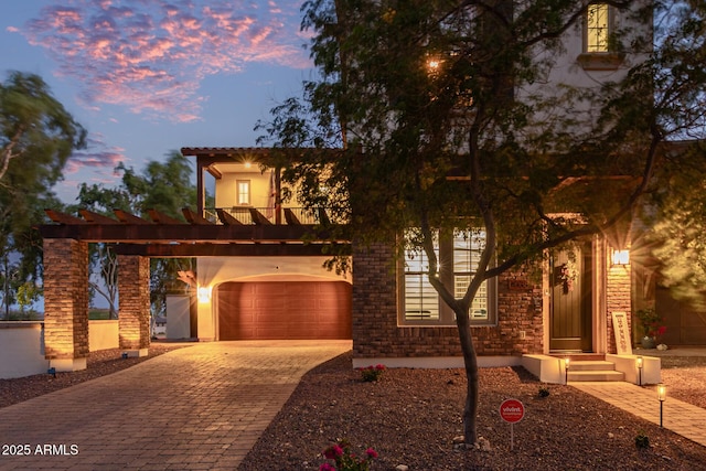 20689 W Valley View Dr, Buckeye, AZ 85396 - view of front of property featuring decorative driveway, an attached garage, stucco siding, and a balcony