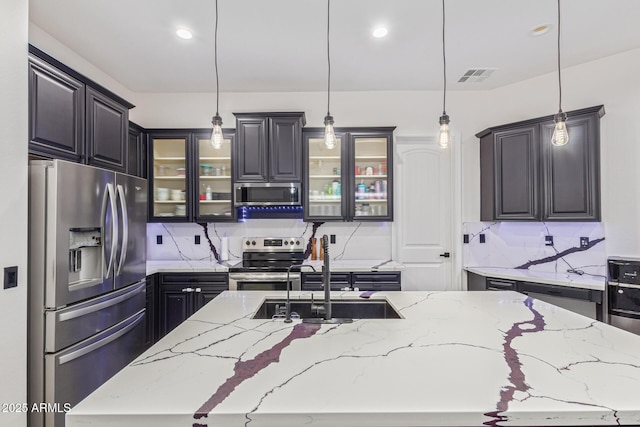 20689 W Valley View Dr, Buckeye, AZ 85396 - kitchen with stainless steel appliances, a sink, backsplash, glass insert cabinets, and recessed lighting