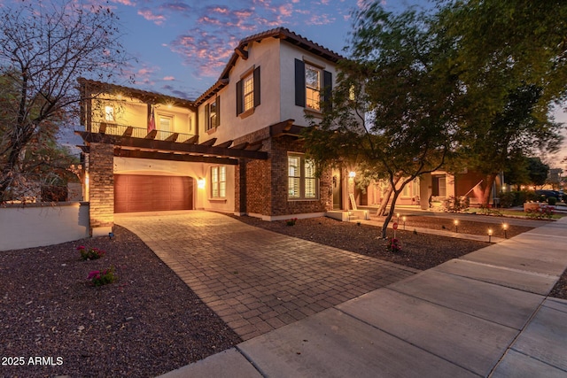 20689 W Valley View Dr, Buckeye, AZ 85396 - mediterranean / spanish home with decorative driveway, stucco siding, a balcony, and an attached garage