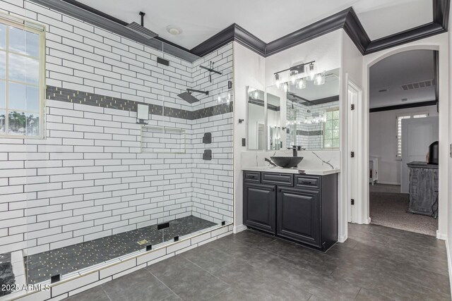 20689 W Valley View Dr, Buckeye, AZ 85396 - bathroom featuring crown molding, a shower stall, vanity, plenty of natural light, and baseboards