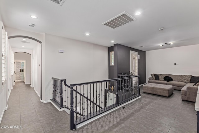 20689 W Valley View Dr, Buckeye, AZ 85396 - hall featuring an upstairs landing, tile patterned flooring, arched walkways, recessed lighting, and healthy amount of natural light