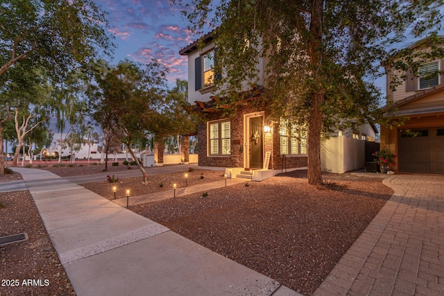 20689 W Valley View Dr, Buckeye, AZ 85396 - view of front of property with brick siding, a garage, and decorative driveway