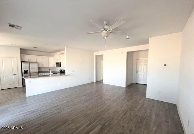 32515 N 214th Ave, Wittmann, AZ 85361 - unfurnished living room featuring ceiling fan, a sink, dark wood finished floors, baseboards, and visible vents