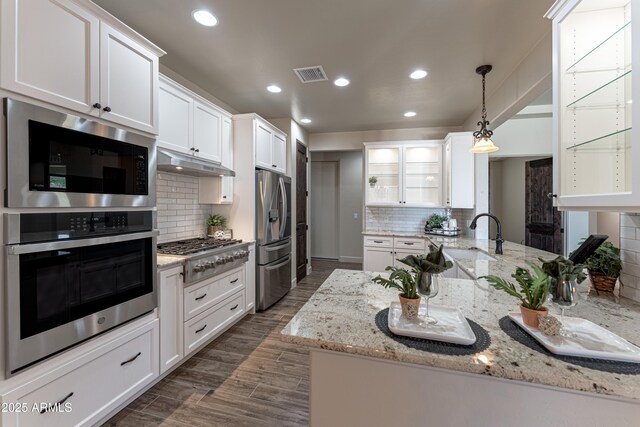 6397 E Red Oak Cir, Hereford, AZ 85615 - kitchen with visible vents, appliances with stainless steel finishes, glass insert cabinets, under cabinet range hood, and white cabinetry