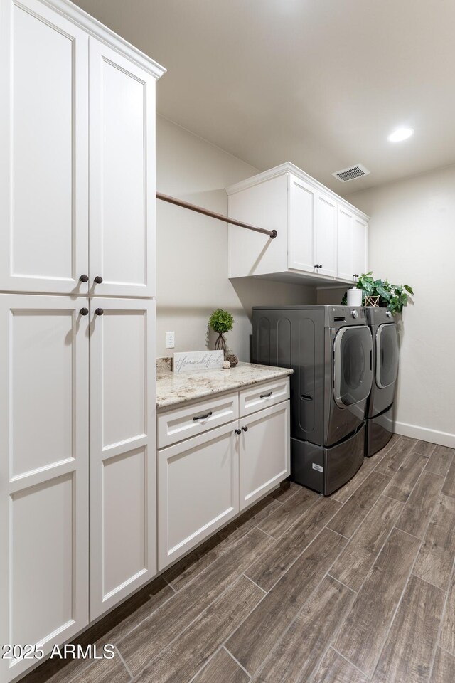 6397 E Red Oak Cir, Hereford, AZ 85615 - laundry room with visible vents, dark wood finished floors, cabinet space, baseboards, and separate washer and dryer