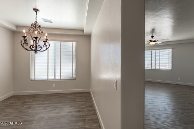 6397 E Red Oak Cir, Hereford, AZ 85615 - spare room with baseboards, ceiling fan with notable chandelier, dark wood-style floors, and visible vents