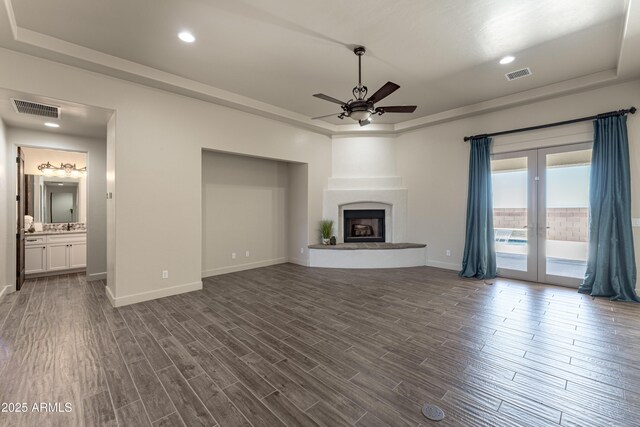 6397 E Red Oak Cir, Hereford, AZ 85615 - unfurnished living room featuring dark wood-style flooring, ceiling fan, visible vents, and french doors