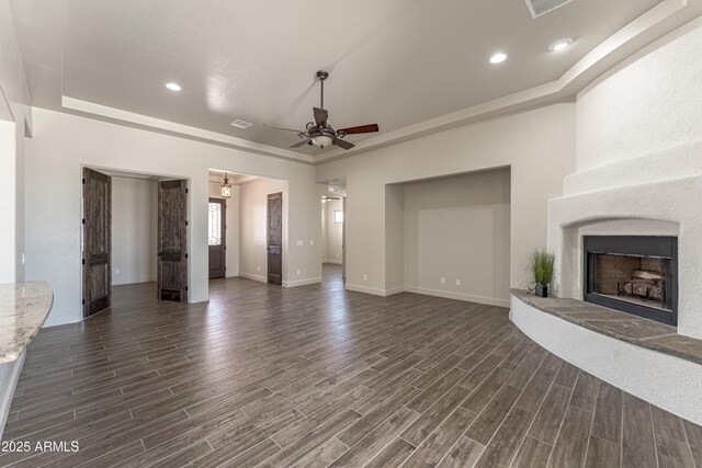 6397 E Red Oak Cir, Hereford, AZ 85615 - unfurnished living room with a ceiling fan, a large fireplace, dark wood finished floors, baseboards, and recessed lighting