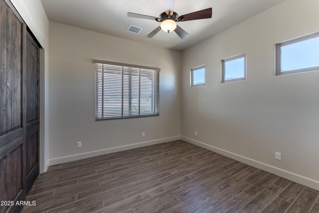 6397 E Red Oak Cir, Hereford, AZ 85615 - unfurnished bedroom with baseboards, dark wood-style flooring, visible vents, and a closet