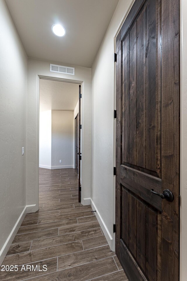 6397 E Red Oak Cir, Hereford, AZ 85615 - hallway with baseboards, dark wood-type flooring, and visible vents
